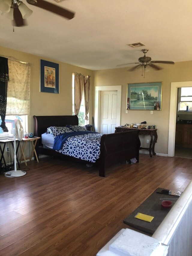 bedroom with ceiling fan, wood-type flooring, a closet, and ensuite bath