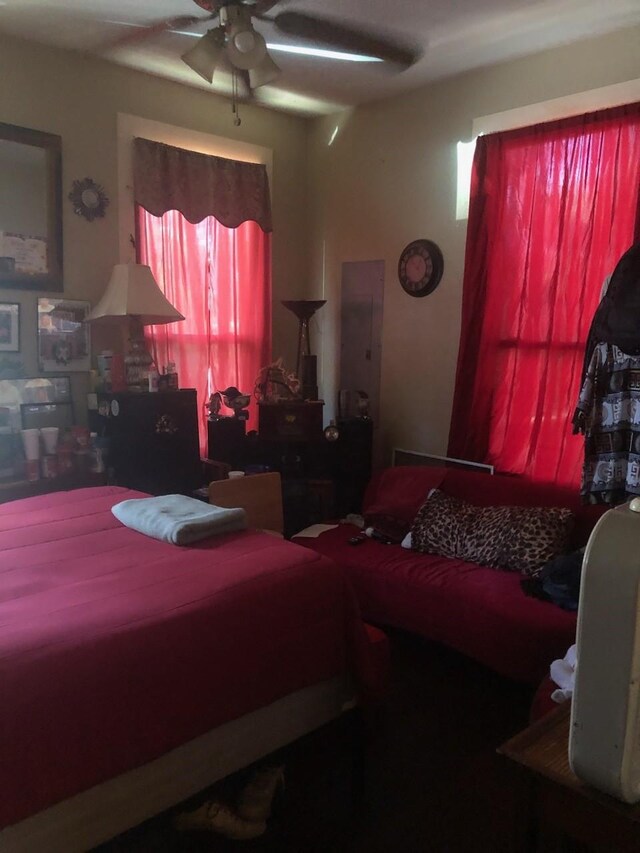 bedroom with ceiling fan and electric panel