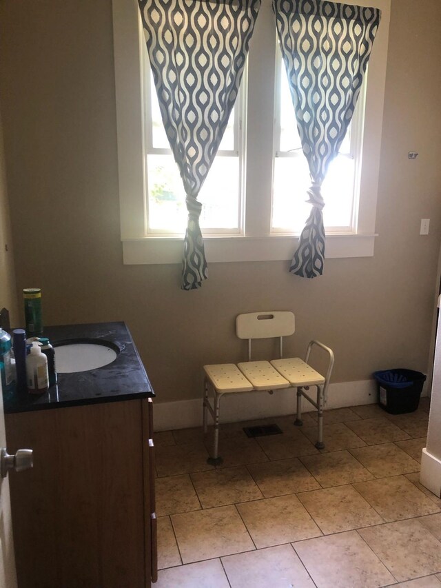 dining space featuring sink and light tile patterned floors