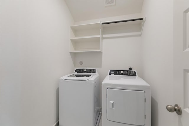 clothes washing area with washer and clothes dryer