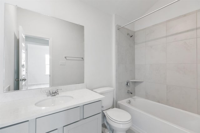 full bathroom featuring toilet, vanity, and tiled shower / bath