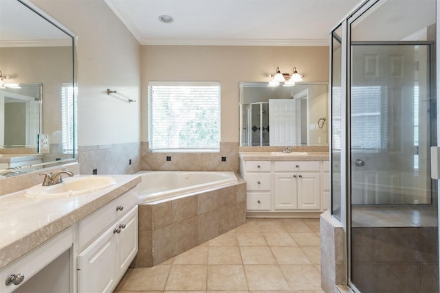 bathroom featuring a garden tub, a sink, tile patterned floors, a stall shower, and crown molding