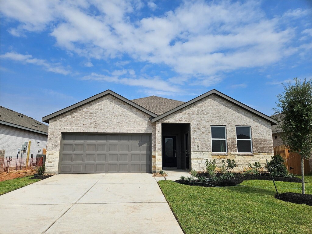 1203 Shady Pines Dr, Beasley, TX 77417 - ranch-style house with driveway, an attached garage, fence, and a front lawn