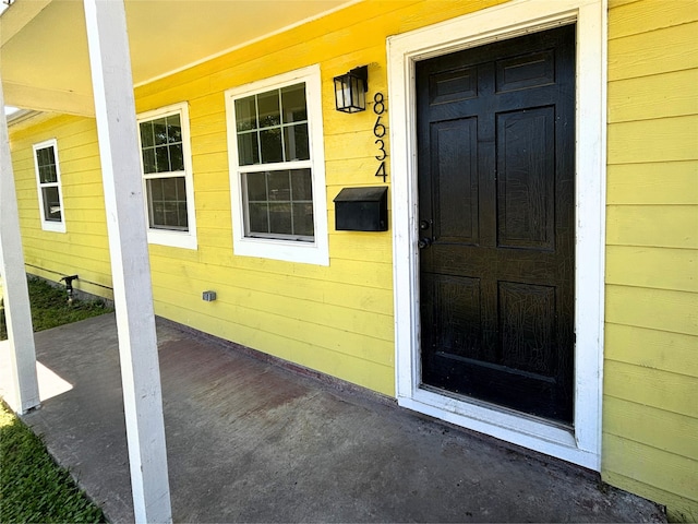 doorway to property with a porch