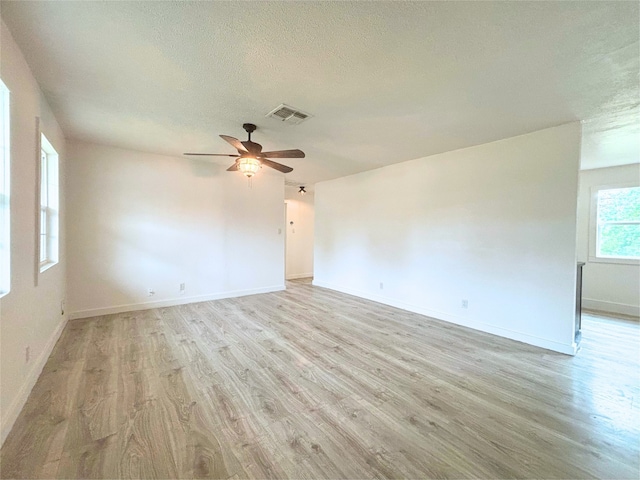 interior space featuring ceiling fan, light hardwood / wood-style flooring, and a textured ceiling