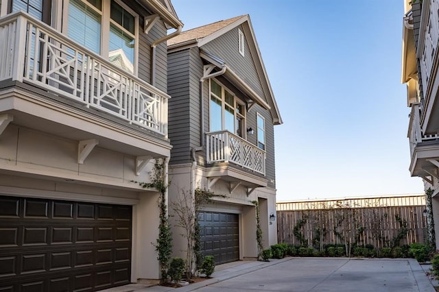 exterior space featuring a garage and a balcony