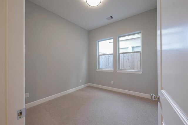 spare room with light colored carpet