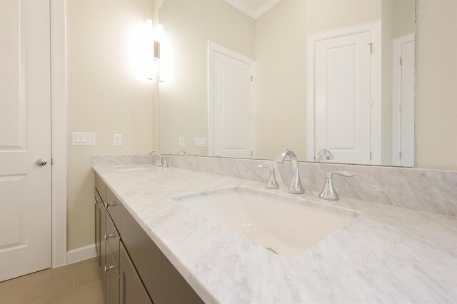 bathroom with tile patterned flooring and double sink vanity