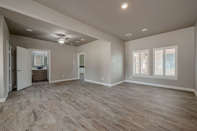 unfurnished living room with ceiling fan and light hardwood / wood-style floors