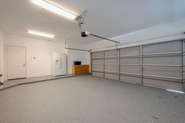 garage featuring white fridge with ice dispenser and a garage door opener