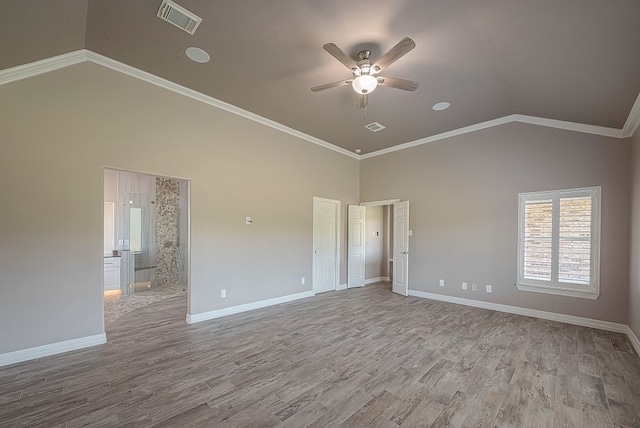 empty room featuring ceiling fan, light hardwood / wood-style flooring, crown molding, and lofted ceiling