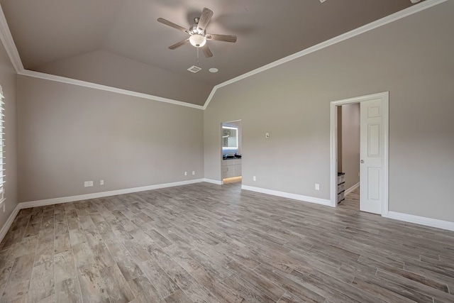 spare room with ceiling fan, light wood-type flooring, lofted ceiling, and ornamental molding