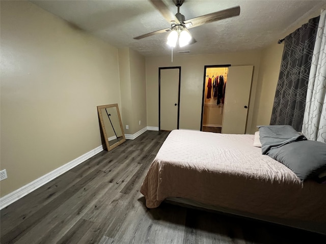 bedroom featuring wood-type flooring, a textured ceiling, and ceiling fan