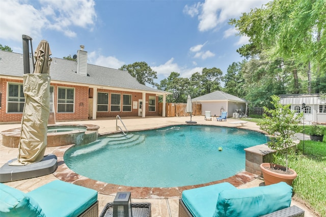 view of pool with an in ground hot tub and a patio area