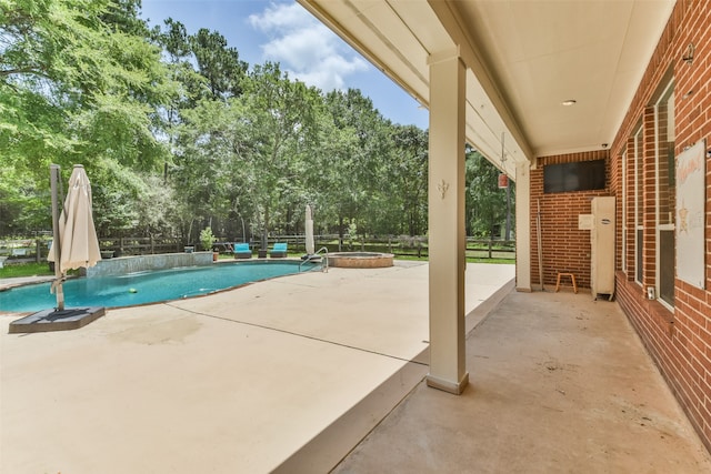 view of swimming pool with a jacuzzi and a patio