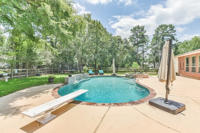 view of pool featuring a diving board and a patio area