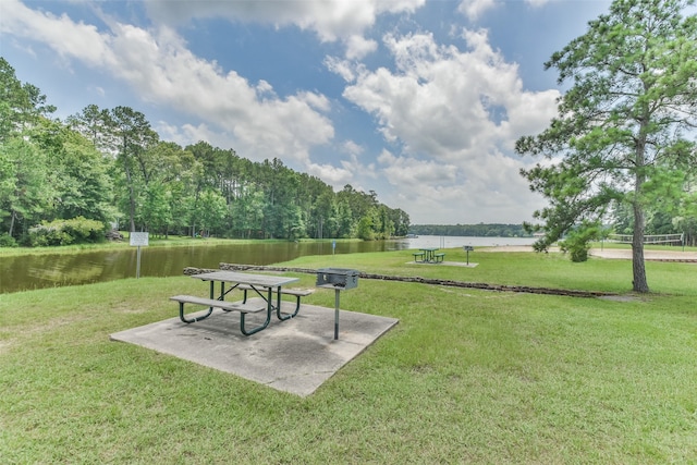 view of community featuring a water view and a yard