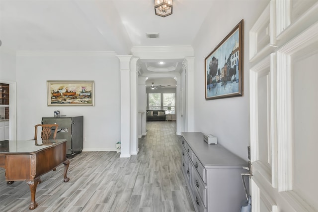 hall featuring ornamental molding, light hardwood / wood-style flooring, and ornate columns