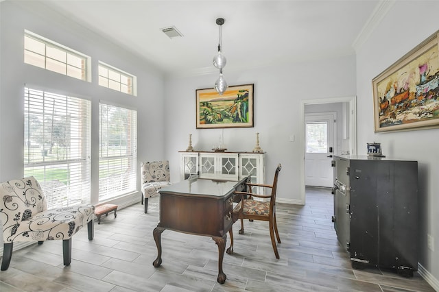 dining area with light hardwood / wood-style flooring and ornamental molding