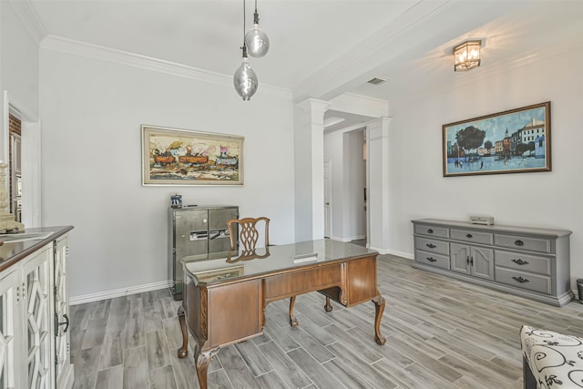 home office with ornate columns, ornamental molding, and light hardwood / wood-style flooring