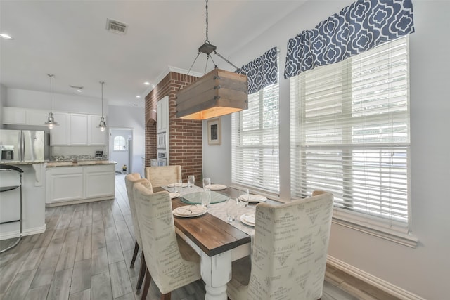 dining room featuring light hardwood / wood-style flooring and a wealth of natural light