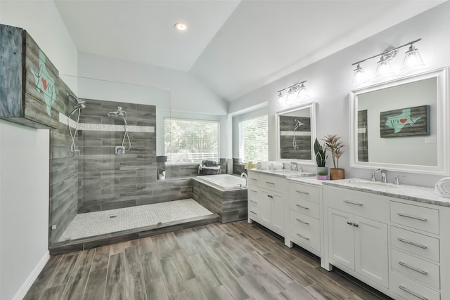 bathroom featuring vanity, lofted ceiling, hardwood / wood-style floors, and separate shower and tub