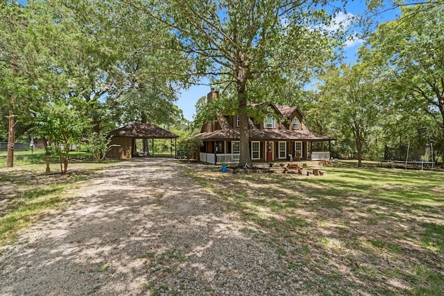 view of front of property with a trampoline and a porch