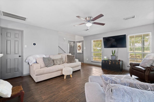 living room featuring ceiling fan and dark hardwood / wood-style flooring