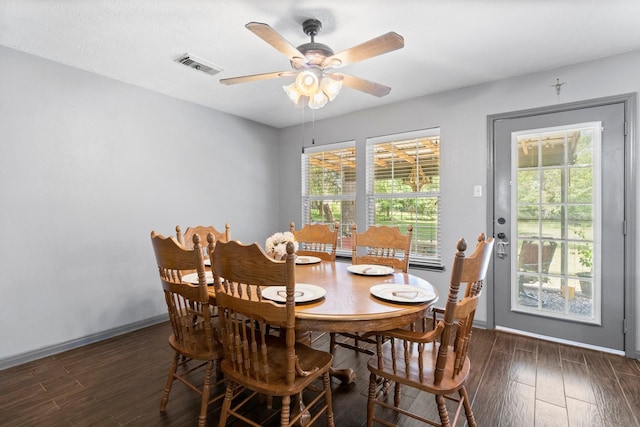 dining space featuring ceiling fan and dark hardwood / wood-style flooring