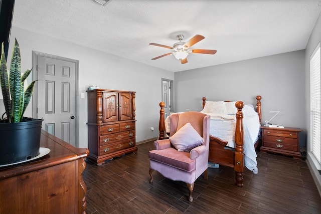 bedroom featuring a textured ceiling, dark hardwood / wood-style floors, and ceiling fan