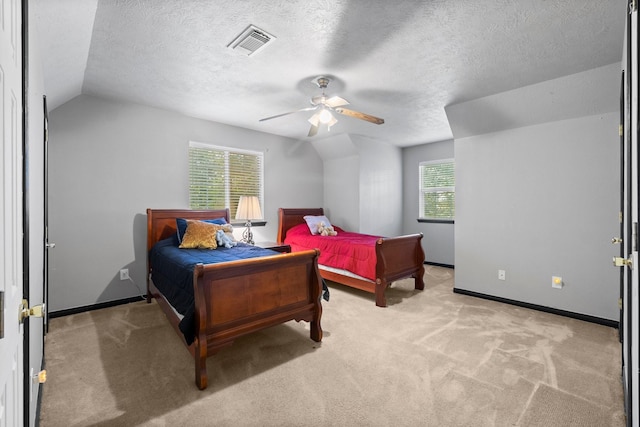 bedroom featuring a textured ceiling, lofted ceiling, and light colored carpet