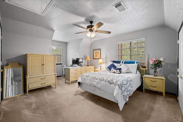 bedroom with ceiling fan, carpet floors, a textured ceiling, and lofted ceiling