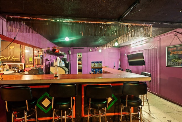 bar featuring light tile patterned floors