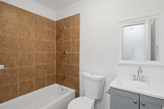 full bathroom featuring tiled shower / bath, toilet, and vanity