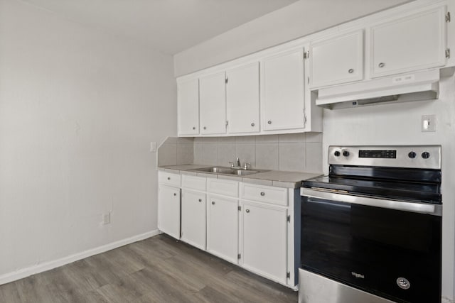 kitchen featuring sink, white cabinetry, electric range, and wood-type flooring