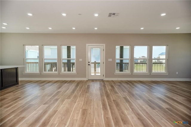 unfurnished living room with light wood-type flooring