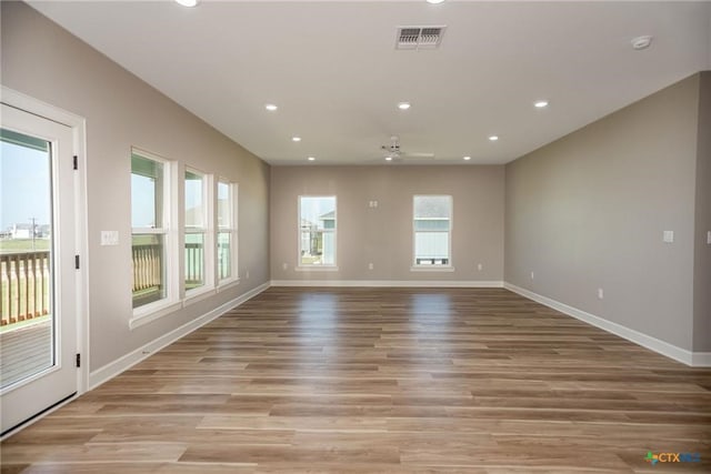 unfurnished living room featuring ceiling fan and light hardwood / wood-style flooring