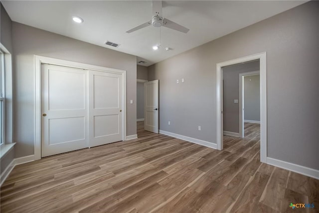 unfurnished bedroom featuring a closet, ceiling fan, and hardwood / wood-style floors