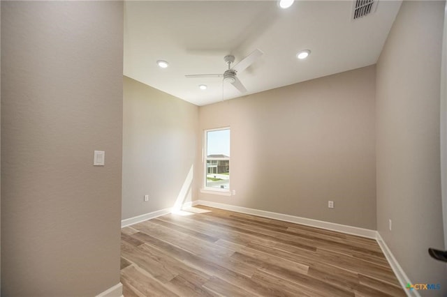 empty room featuring hardwood / wood-style flooring and ceiling fan