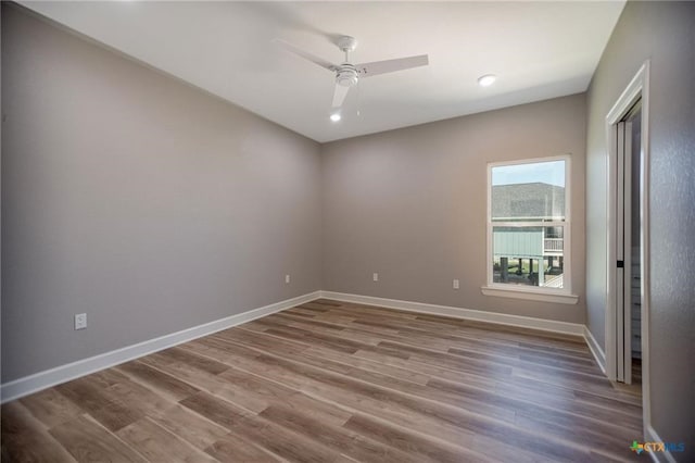 spare room featuring hardwood / wood-style flooring and ceiling fan