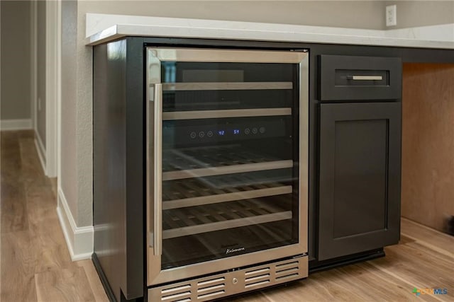 interior details featuring light hardwood / wood-style floors and beverage cooler