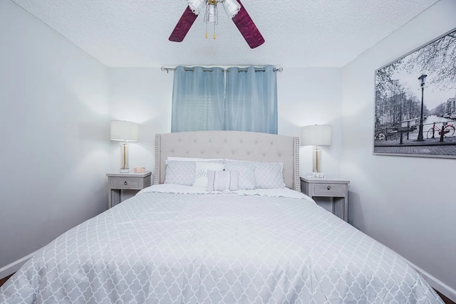 bedroom with ceiling fan and a textured ceiling