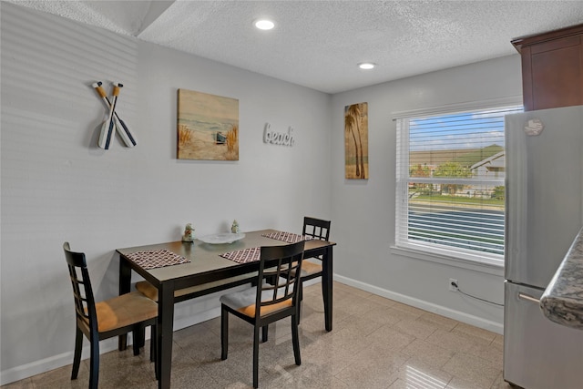 dining room with a textured ceiling