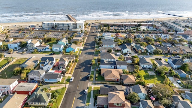 drone / aerial view with a beach view and a water view