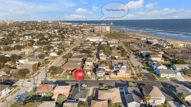 birds eye view of property with a water view and a beach view