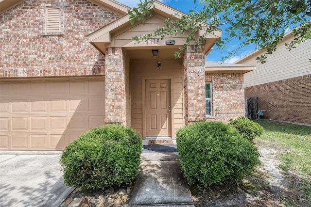 view of exterior entry with a garage