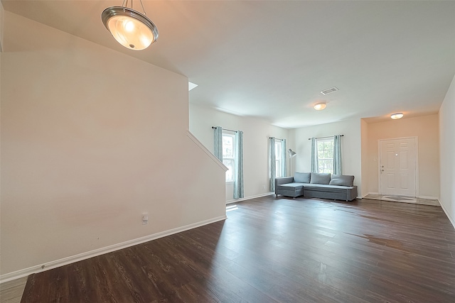 unfurnished living room featuring dark hardwood / wood-style flooring