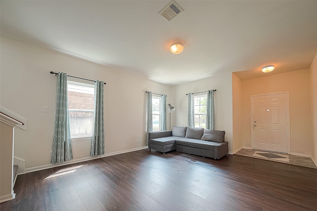 unfurnished living room with dark hardwood / wood-style flooring