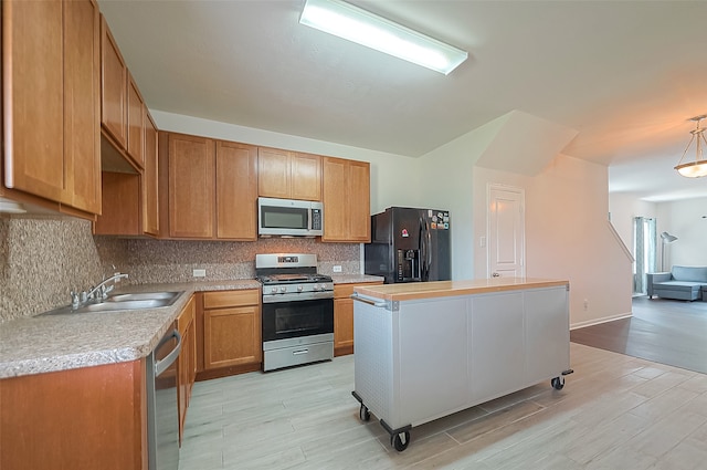 kitchen with decorative backsplash, light hardwood / wood-style floors, sink, a center island, and stainless steel appliances