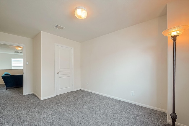 unfurnished bedroom with dark carpet